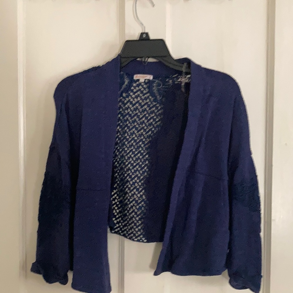Blue high low sweater with Open back designs.